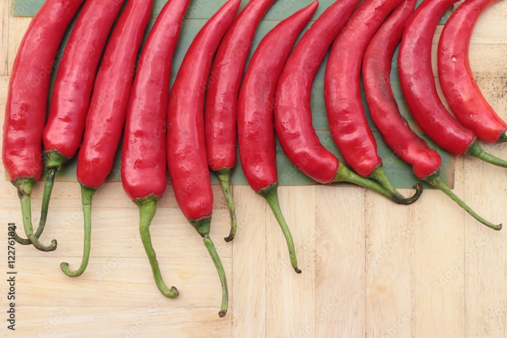 Fresh red hot chilli on wood background. Fresh red hot chilli on wood background.