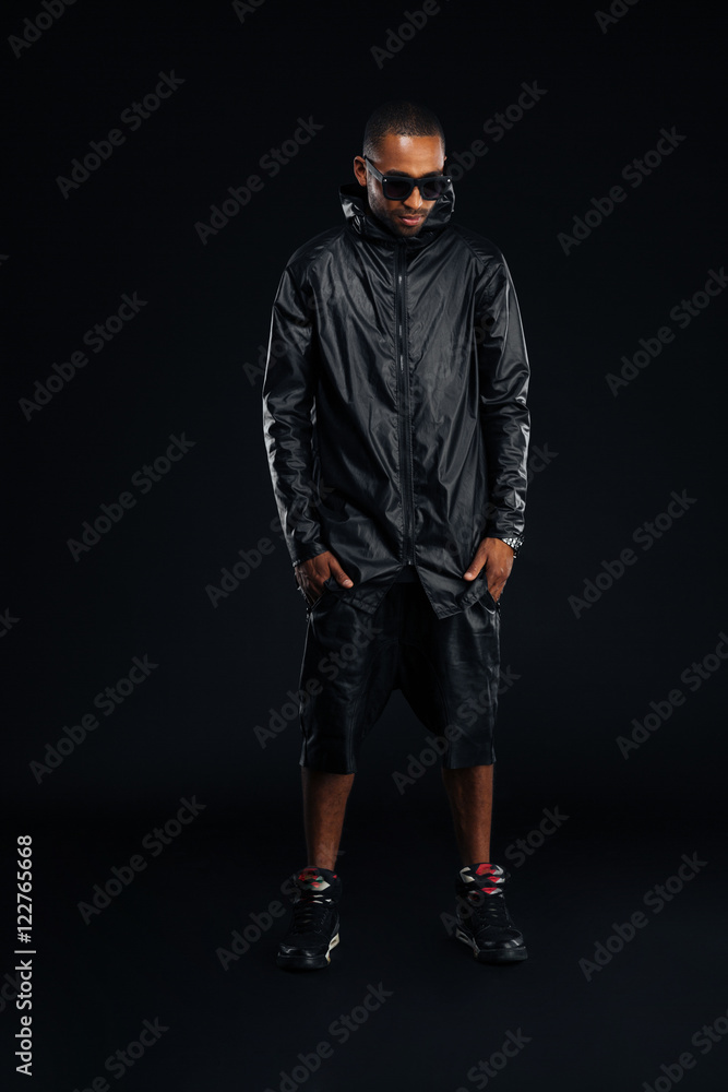 African man in trendy cloth posing with hands in pockets African man in trendy cloth posing with hands in pockets