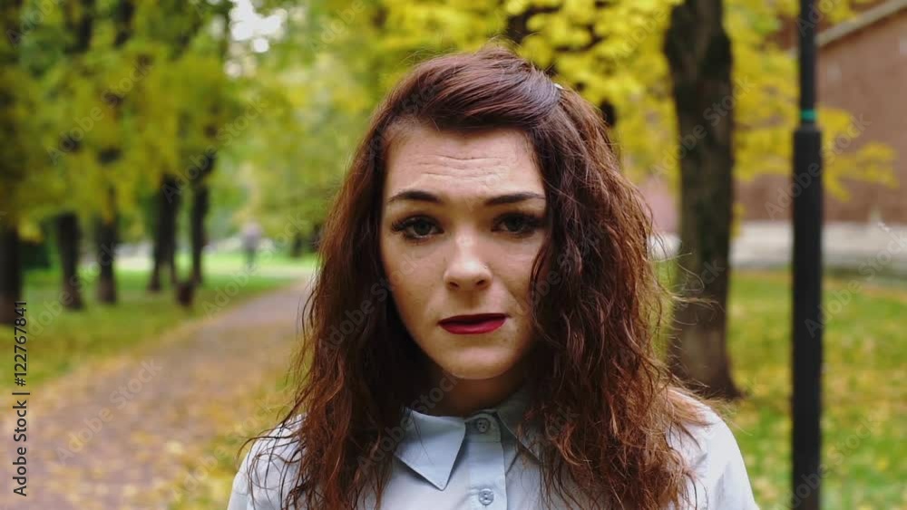 Upset young redhead woman in a park Upset young redhead woman in a park