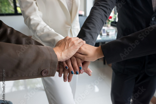 Group of business hands together in office.