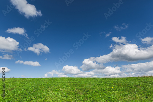 Green meadow and sky with clouds