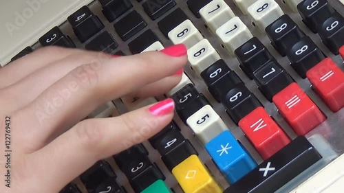 A human hand working old a cash register