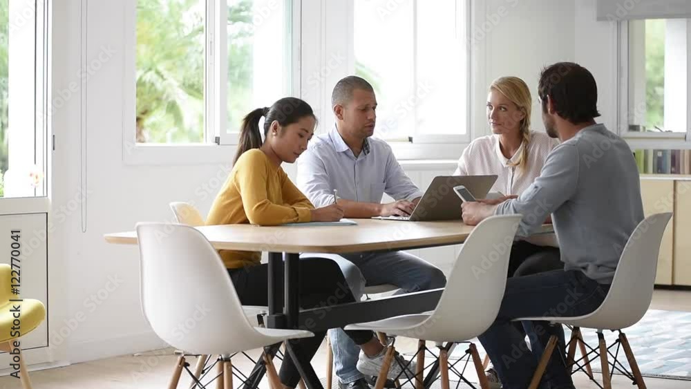 Business people meeting around table in office Business people meeting around table in office