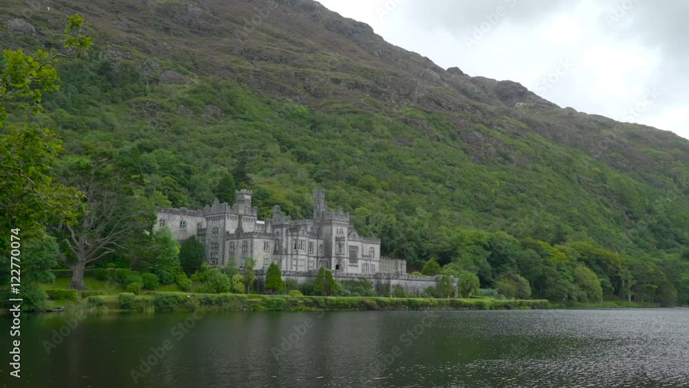 The Kylemore Abbey monastery in Ireland the big palace like building with a big mountain at the back and a river in front The Kylemore Abbey monastery in Ireland the big palace like building with a big mountain at the back and a river in front