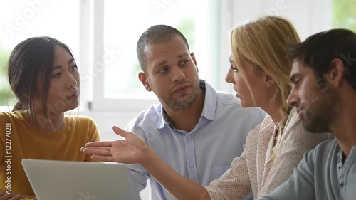 Business workgroup interacting in office