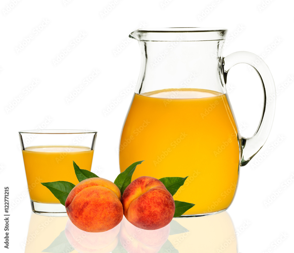 peach juice in a glass and carafe peach juice in a glass and carafe