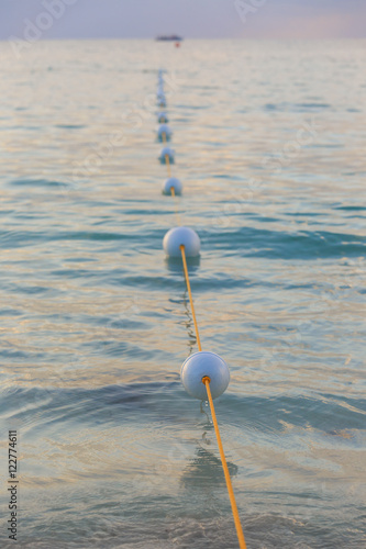  Buoys floating off a Caribbean beach. photo