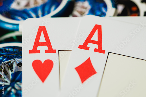 Zwei Asse auf dem Tisch mit Chips im Hintergrund