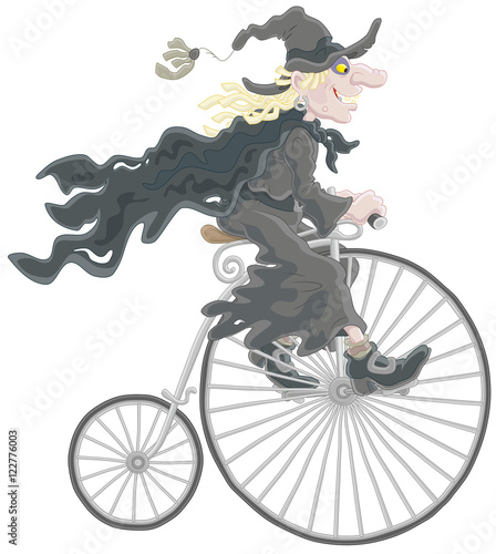 Halloween witch riding an antique bicycle photo