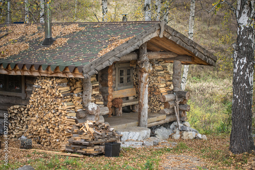 old wooden house in the autumn forest 