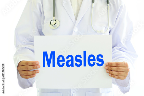 Doctor holding Measles card in hands photo