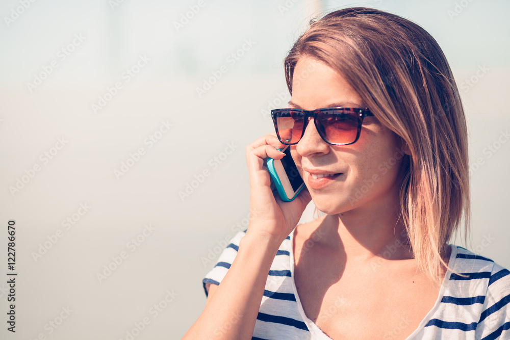 Young woman using smartphone in public Young woman using smartphone in public