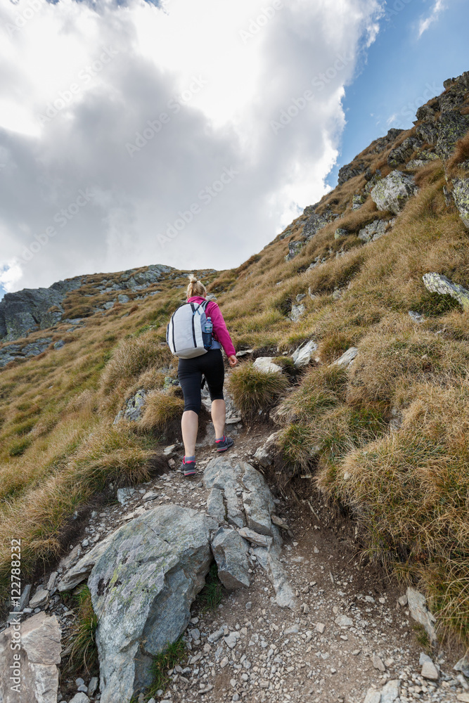 Woman backpacker hiking on a trail