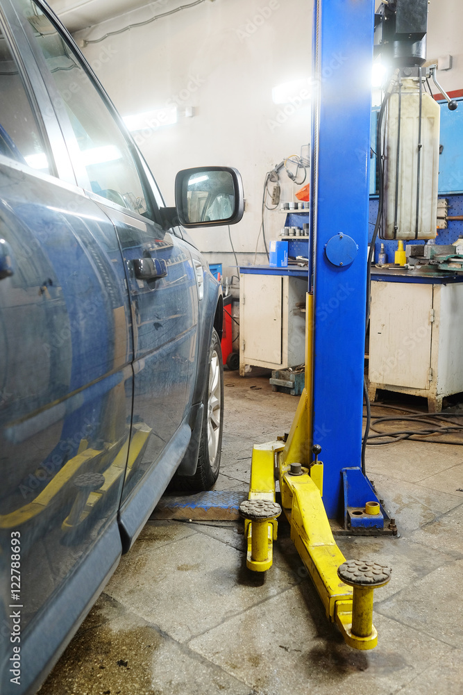 Moscow, Russia - October, 3, 2016: Working shop in a car repair station in Moscow, Russia Moscow, Russia - October, 3, 2016: Working shop in a car repair station in Moscow, Russia