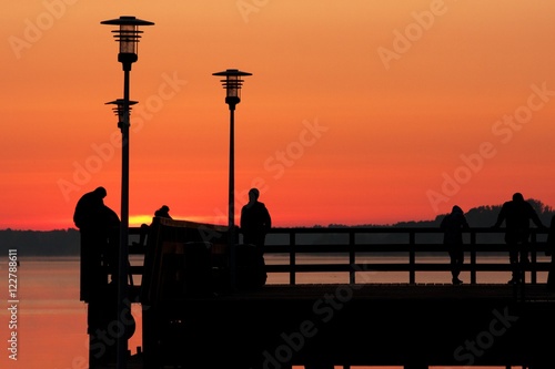 people on the bridge at sunrise