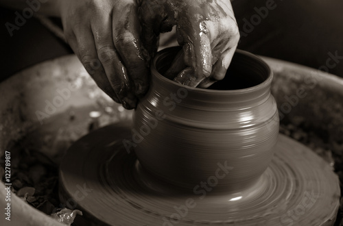 Photography Potter shaping clay on the pottery wheel