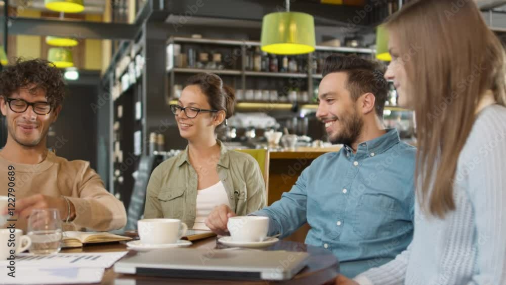 Small Creative Team of Active Young People Having Meeting and Discussion in Coffee Shop. Shot on RED Cinema Camera in 4K (UHD). Small Creative Team of Active Young People Having Meeting and Discussion in Coffee Shop. Shot on RED Cinema Camera in 4K (UHD).