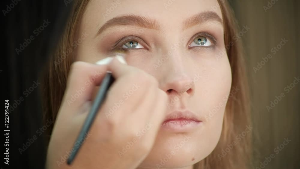 the Make-Up Stylist Doing a Make-Up to Hipster Model the Make-Up Stylist Doing a Make-Up to Hipster Model