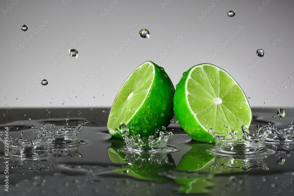 Lime with water drops on grey background
