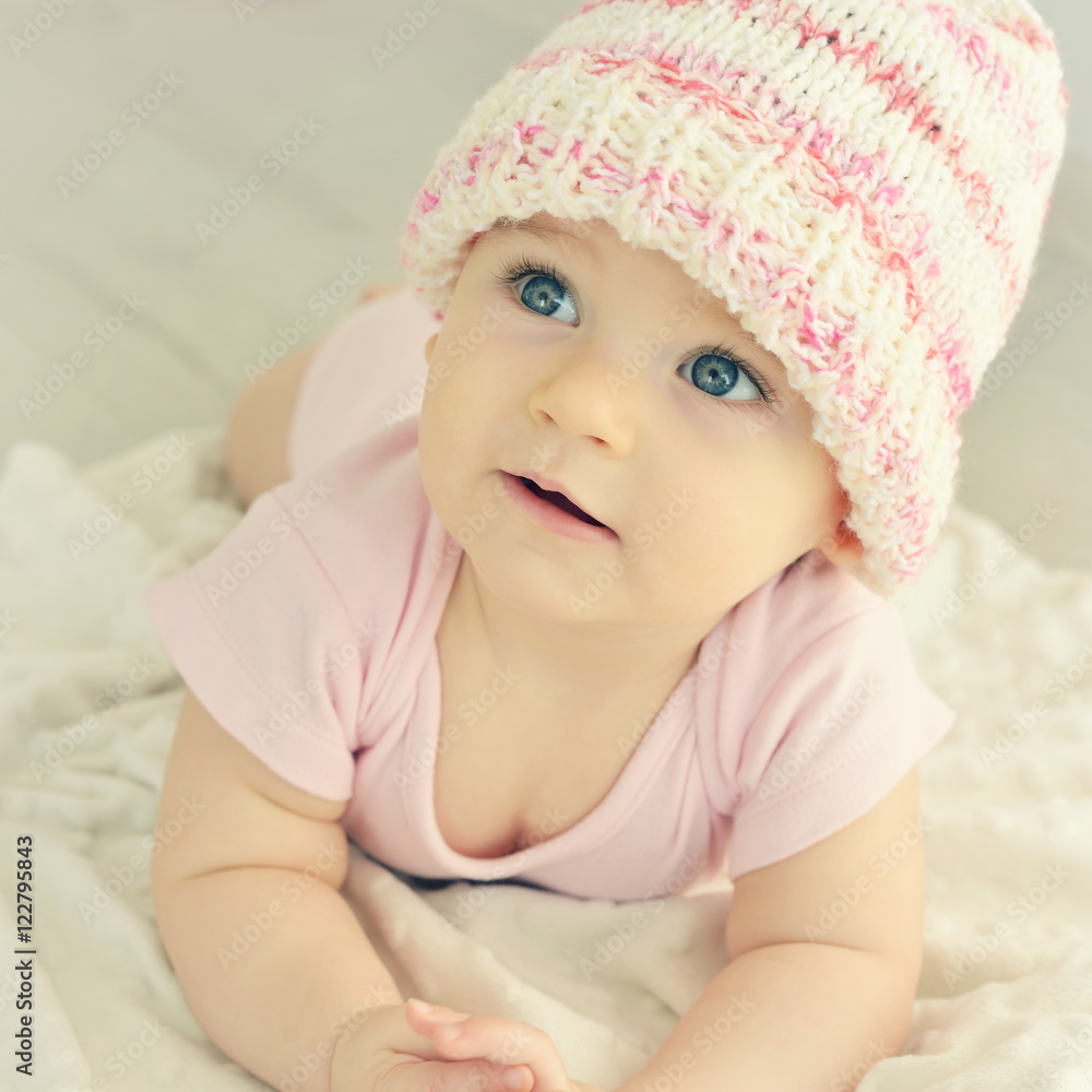A cute little baby. Newborn baby girl in pink knitted hat. Parenting or love concept. Toned photo. A cute little baby. Newborn baby girl in pink knitted hat. Parenting or love concept. Toned photo.
