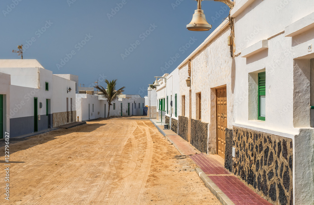 Sandy alleyway between the houses on the island of La Graciosa.