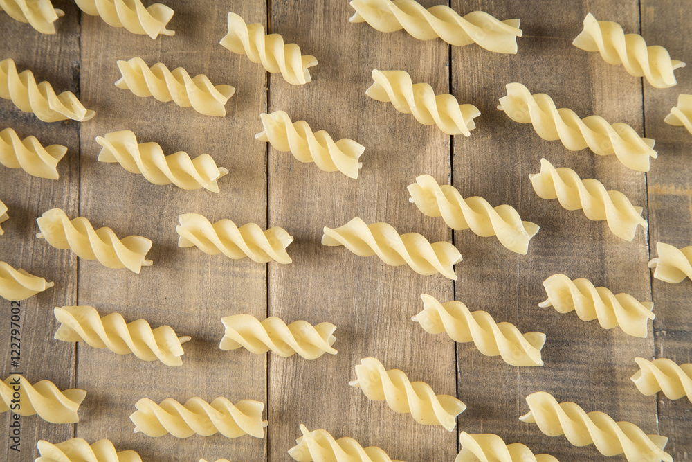 Fusilli pasta on wooden background Fusilli pasta on wooden background