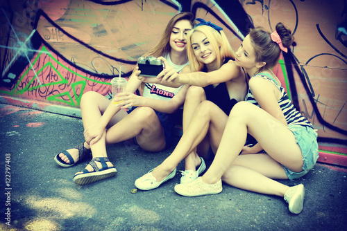 Urban girls have fun with retro vintage photo camera outdoor nea