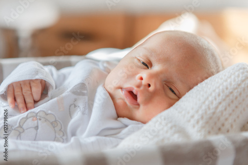 Newborn baby boy lying in a basket