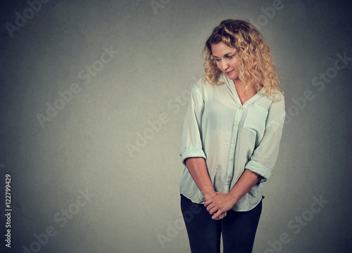 Papier peint Shy insecure young woman looking down
