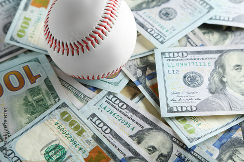 Baseball ball on money bills
