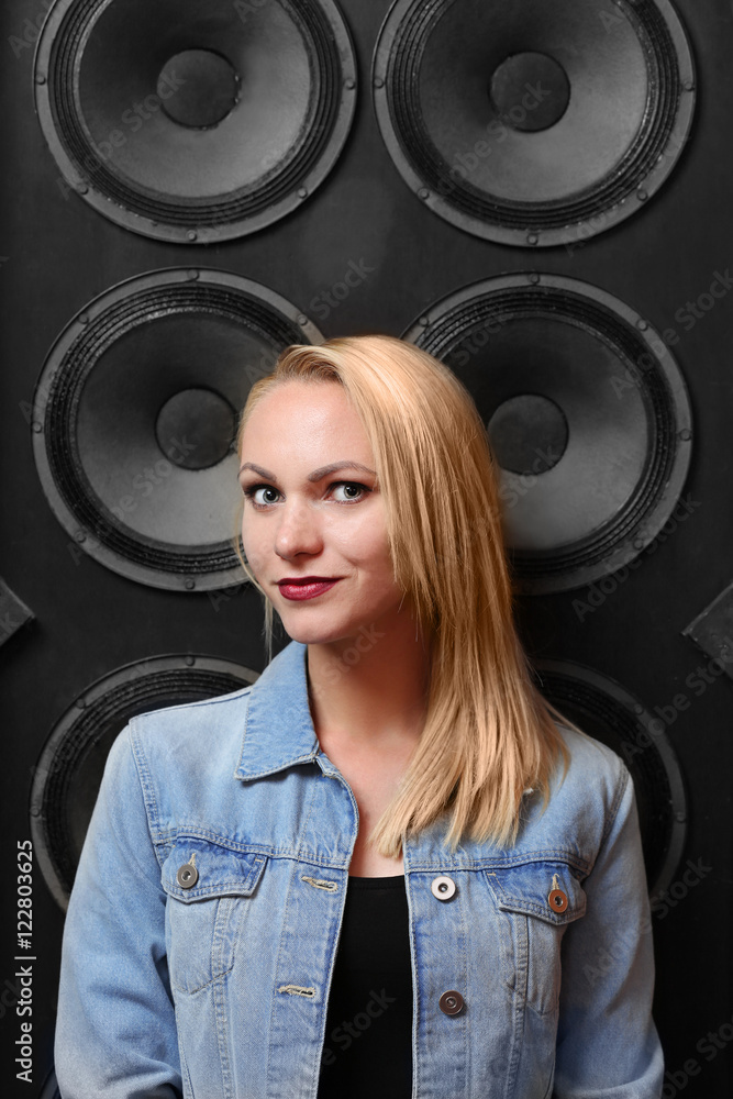 Young woman on audio system background Young woman on audio system background