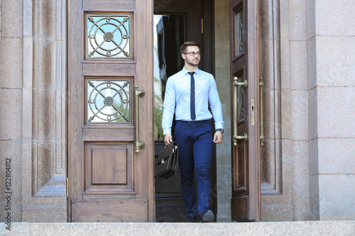Handsome young lawyer  leaving building © Africa Studio