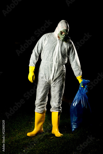 man in bio hazard protective suit with gas mask and gloves photo