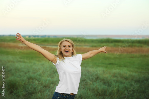 Happy woman on field background