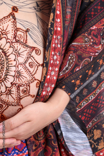 Henna tattoo on pregnant belly, closeup