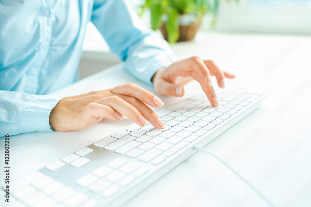 Woman office worker typing on the keyboard Woman office worker typing on the keyboard