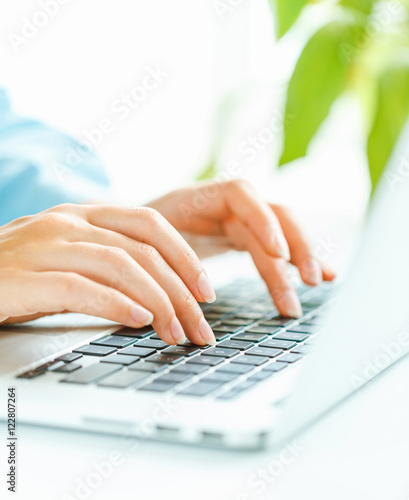 Woman office worker typing on the keyboard