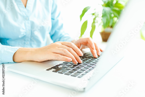 Woman office worker typing on the keyboard