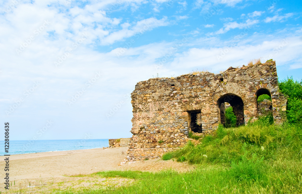Beautiful tropical beach landscape with ruins of castle