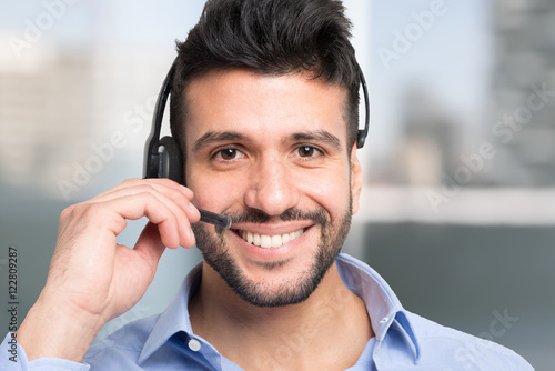 Smiling man using an headset