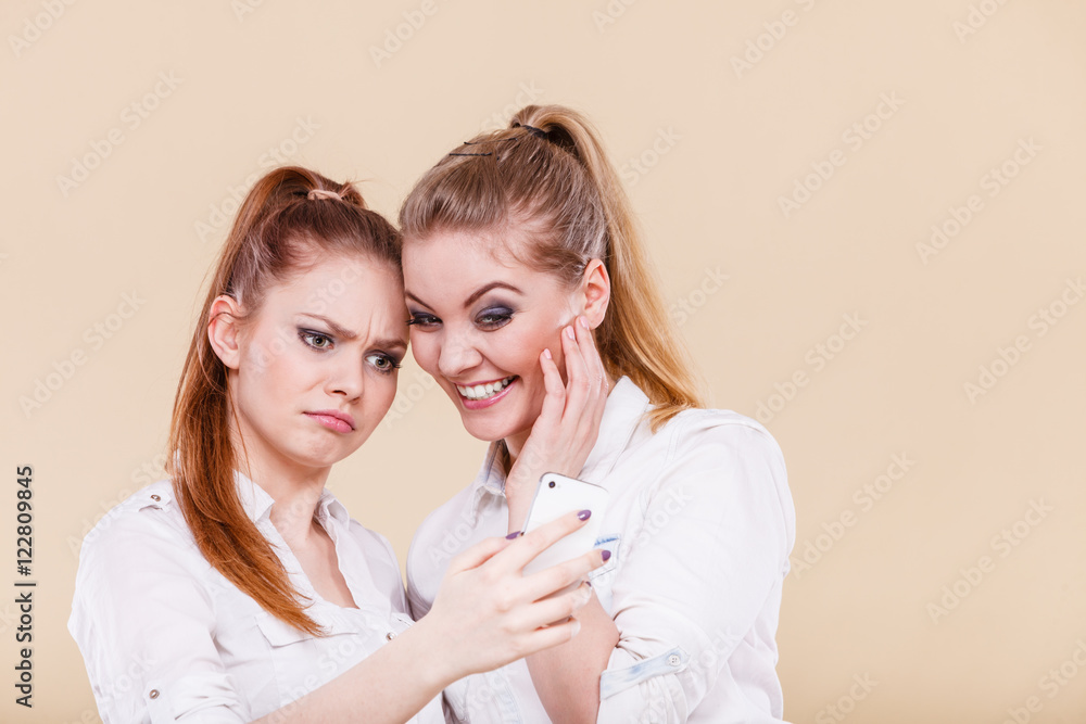 Girls using mobile phone reading message Girls using mobile phone reading message