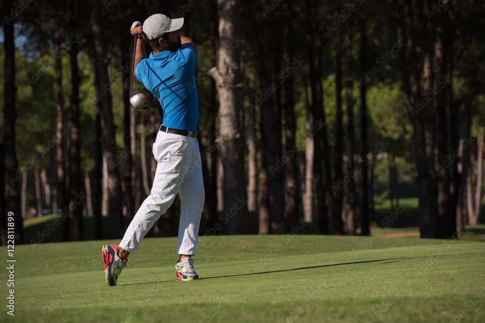 golf player hitting long shot