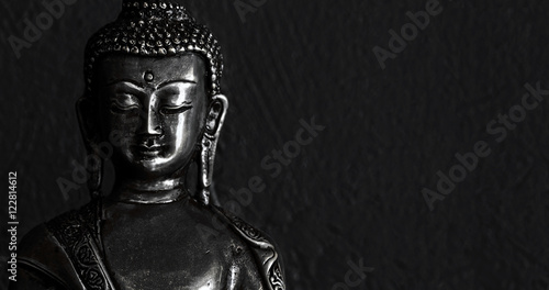 Obraz na płótnie Traditional bronze Buddha statue isolated on black background.