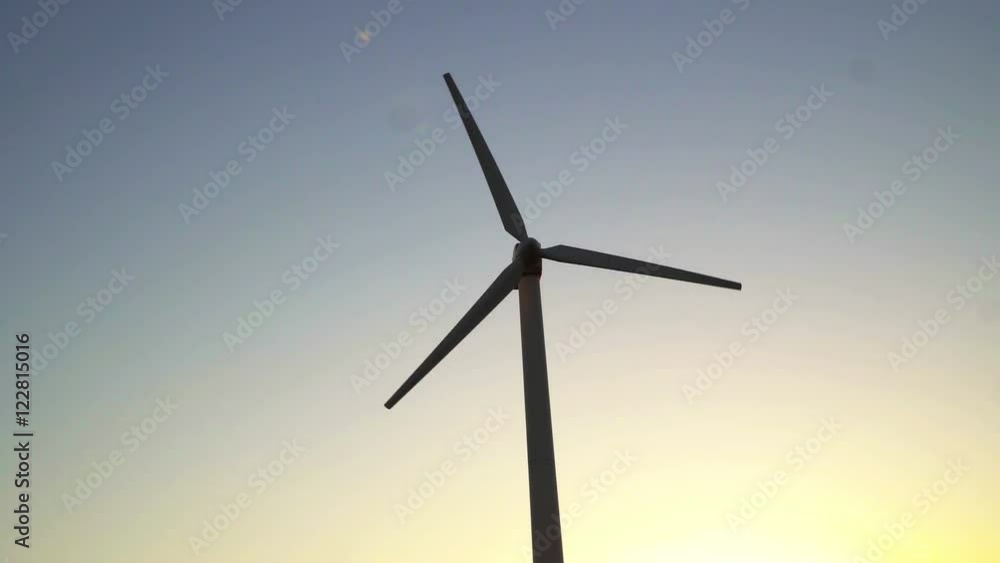 Wind Turbines. modern wind turbines generating sustainable energy in a field with wheat. Wind Turbines. modern wind turbines generating sustainable energy in a field with wheat.