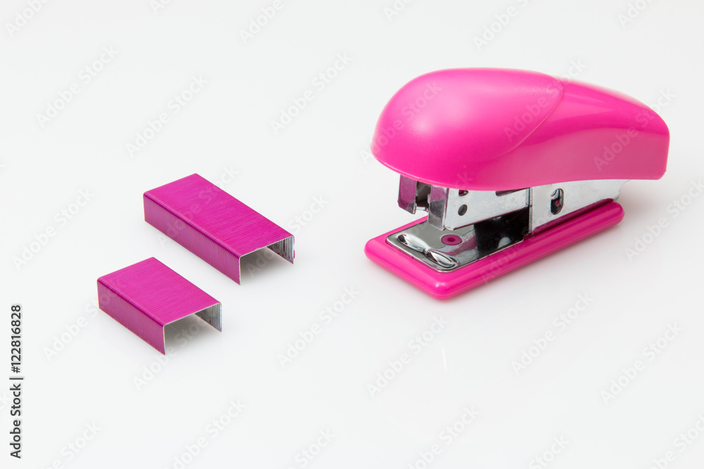 Pink stapler and staples on white Pink stapler and staples on white