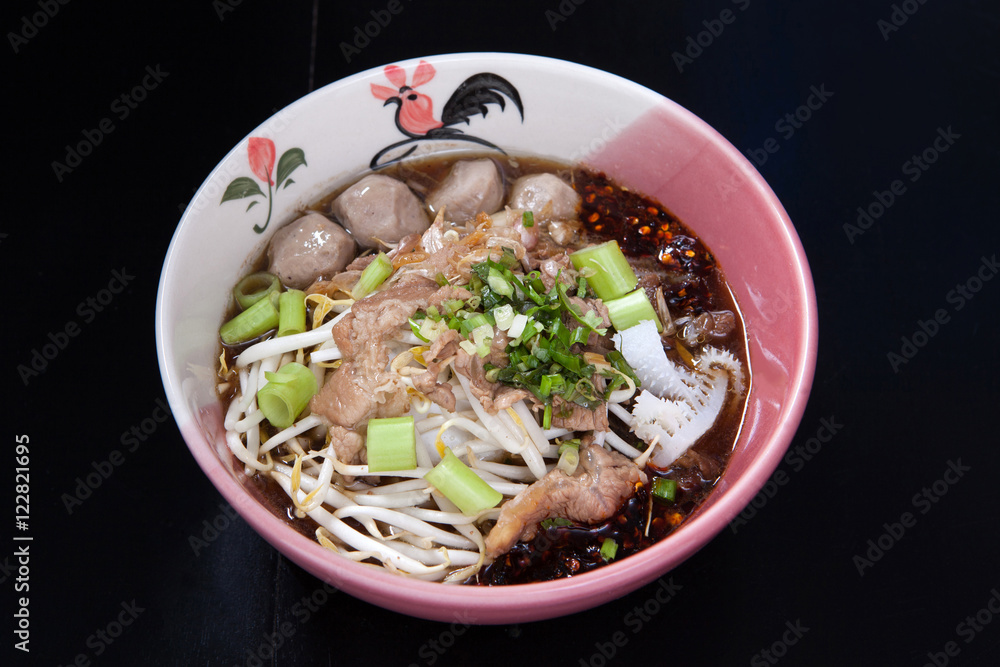 Rice noodle soup with Stewed beef with thai style on black wood Rice noodle soup with Stewed beef with thai style on black wood