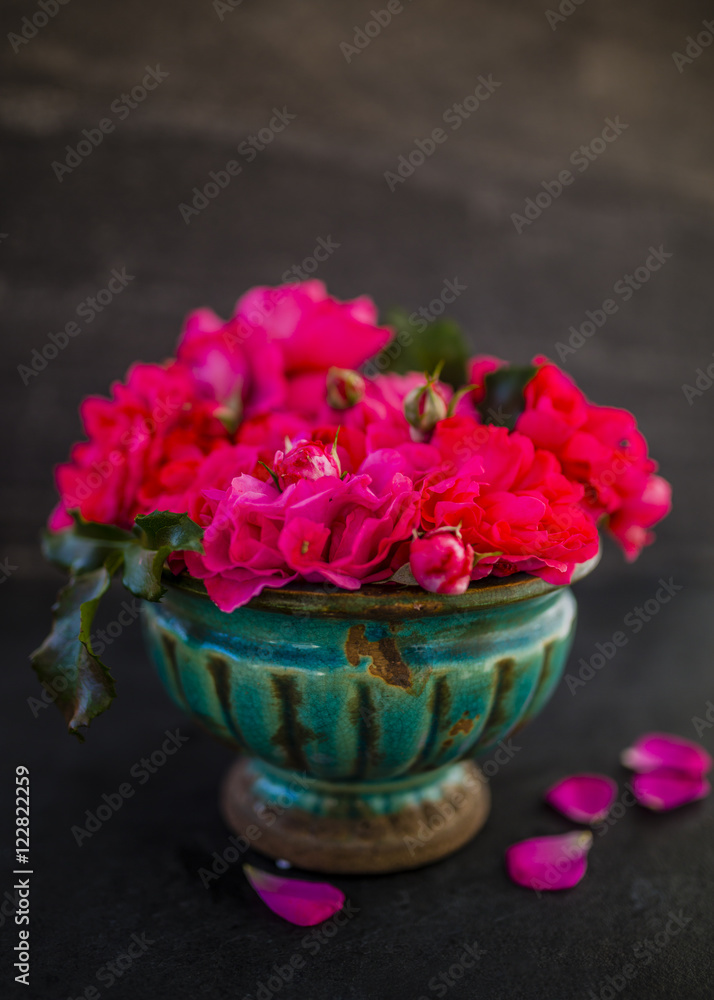 Beautiful pink roses in an old vase. Still life on dark background. Beautiful pink roses in an old vase. Still life on dark background.