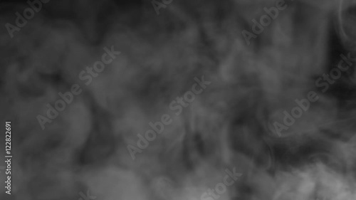 Real white steam looking like smoke isolated on black background. Clouds of white fantasy smoke abstract magic mystic fog toxic gas fumes pollution. Slow motion. Camera locked down. Recorded in 60fps