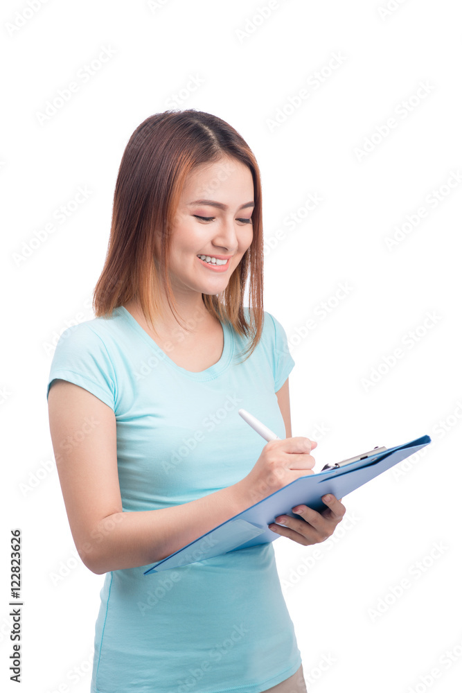 Portrait of young happy smiling asian woman writting on blue fol Portrait of young happy smiling asian woman writting on blue fol