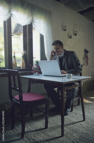 Businessman is Working with Mobile Phone and Laptop